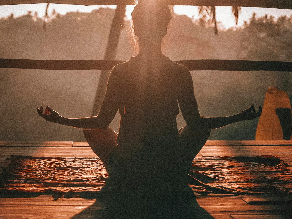 Yoga practice on mountain terrace with sunrise over Mont Blanc